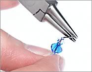 Pliers gripping loose end of wire
